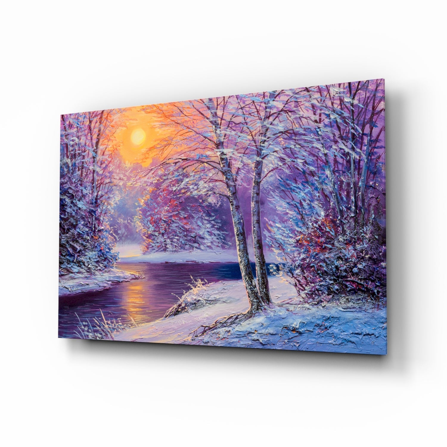 Glass wall art displaying a snow-covered forest path beside a frozen river at sunset, with purple, blue, and golden tones.