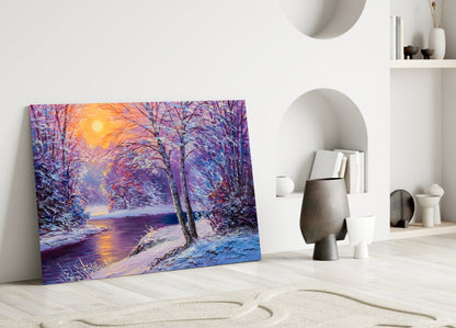 Colorful glass wall art leaning against white wall displays vibrant purple, blue, and golden sunset winter landscape with snow-covered trees and frozen river.
