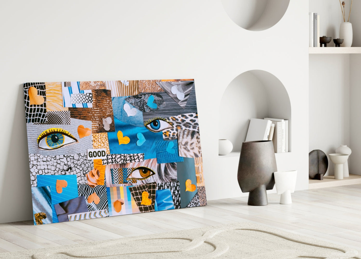 Colorful glass wall art leaning against white wall displaying patchwork of eyes, hearts, patterns in blue, orange, and black.