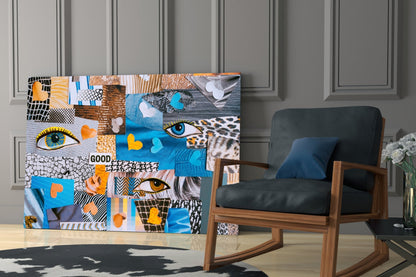 Colorful abstract glass wall art panel with patchwork design featuring eyes, hearts, patterns in blue, orange, and black displayed in modern room setting.