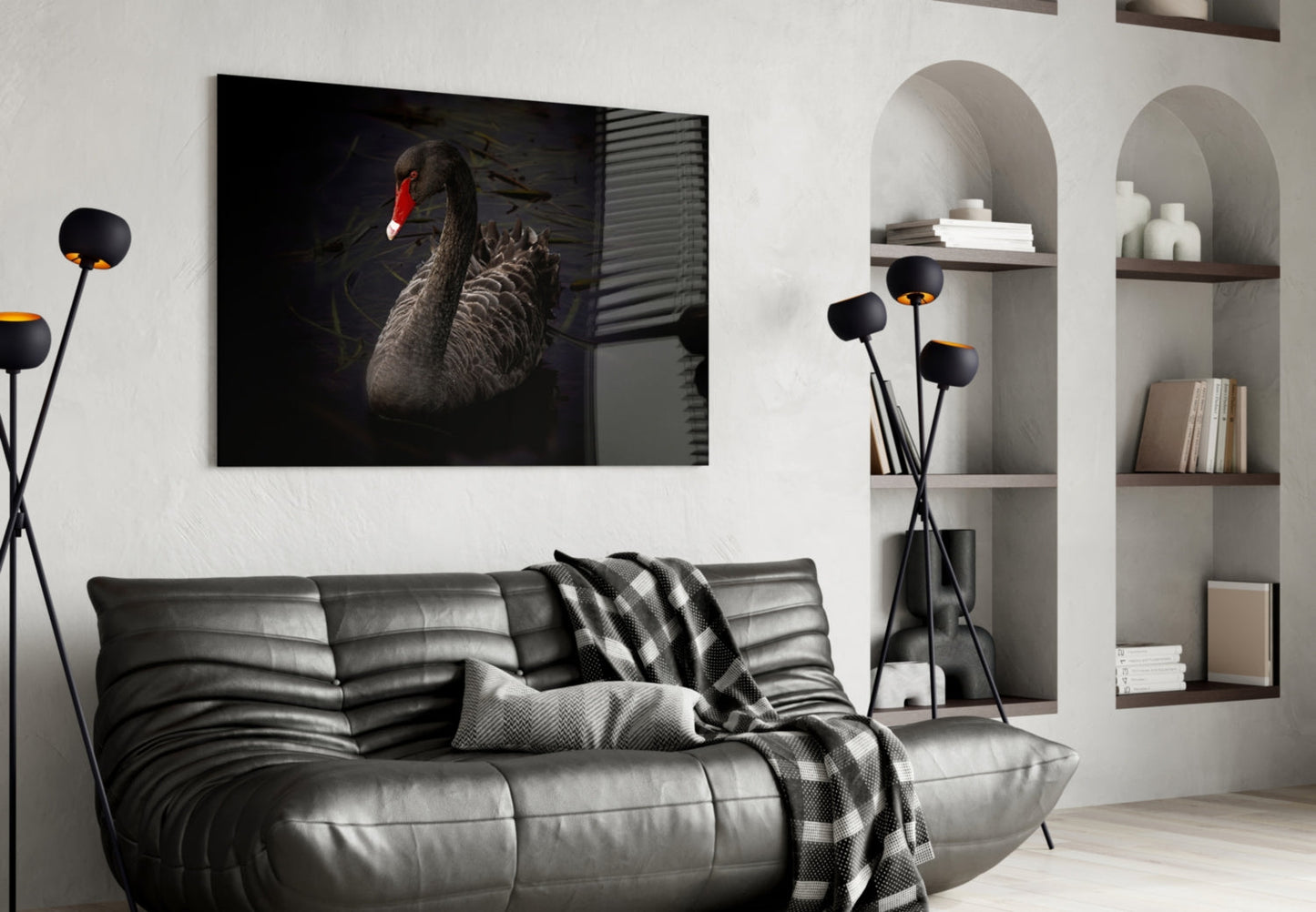 Black Swan glass wall art displayed above a gray leather sofa in a modern living room interior.