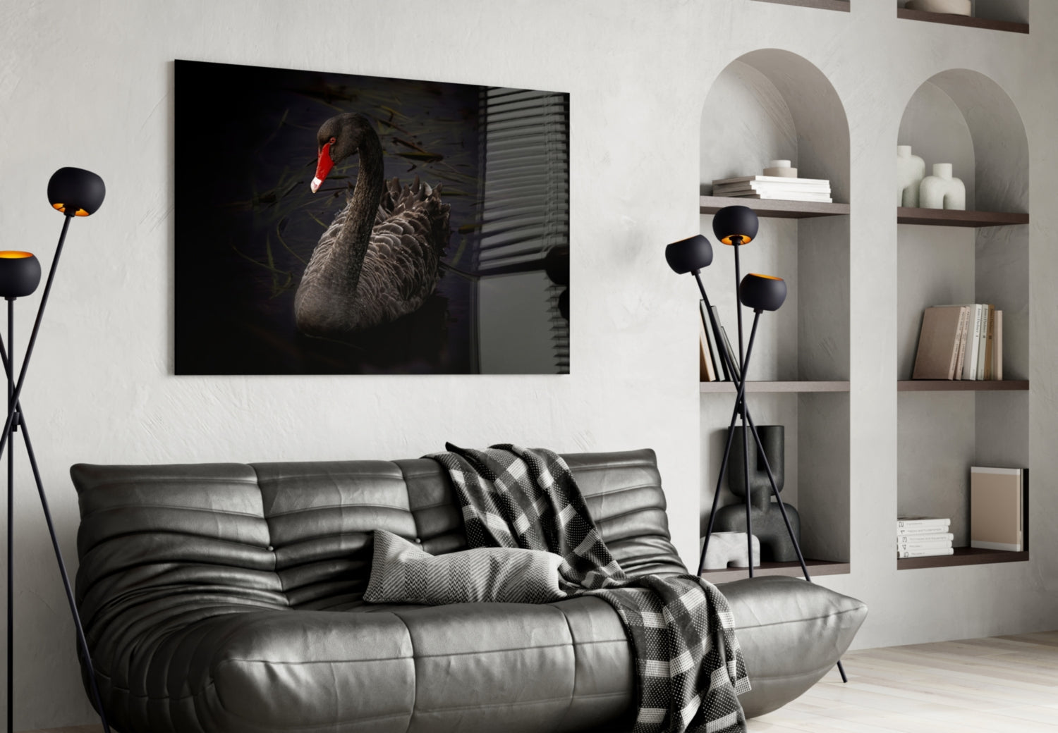 Black Swan glass wall art displayed above a gray leather sofa in a modern living room interior.