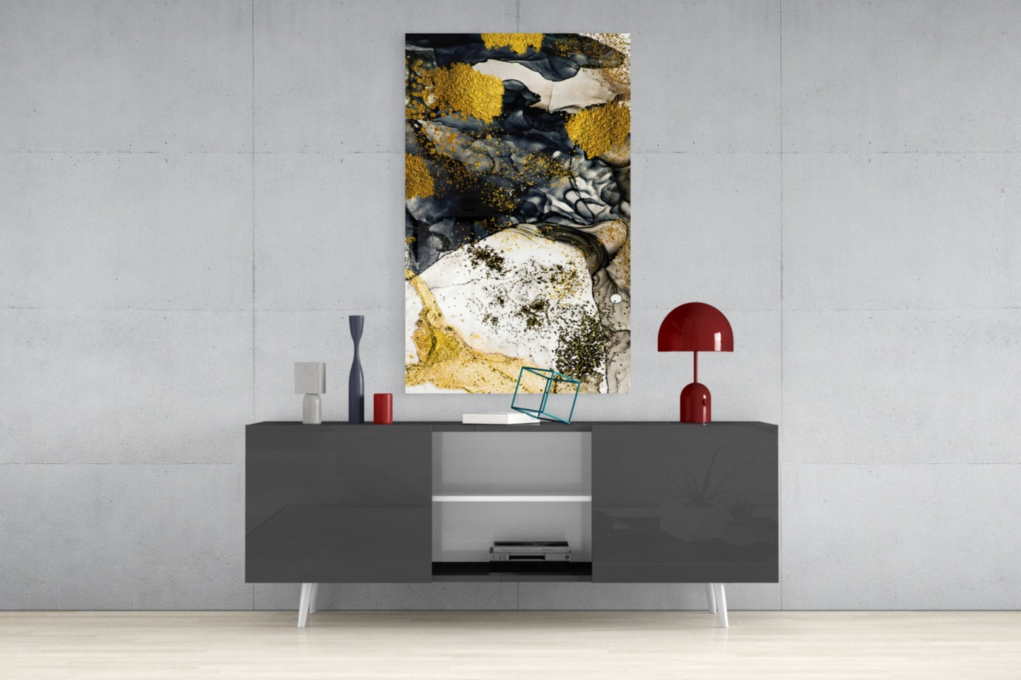 Abstract glass wall art featuring gold, black, and white textures displayed above modern gray media console in contemporary interior setting.