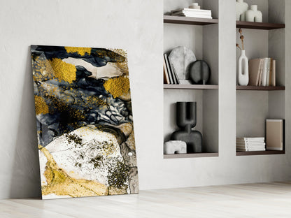 Dance of Yellow Glass Wall Art leaning against white wall beside shelving unit displaying books and decorative objects.