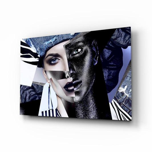 Angled three-quarter view of glass wall art featuring a split-face portrait in denim blue, black, white, and glitter finishes with geometric overlays.