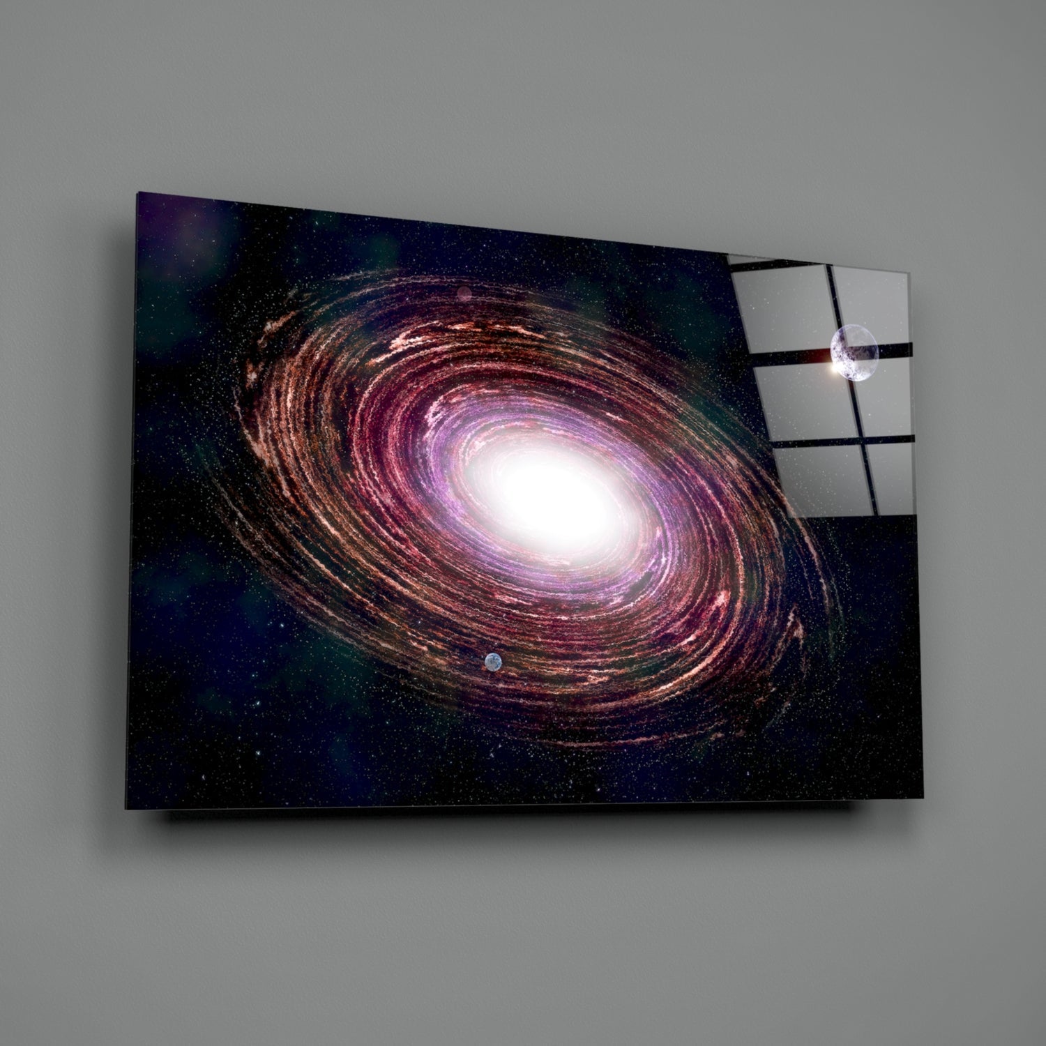 Glass wall art displaying a spiral galaxy with purple, gold, and white tones against a starry dark background, shown at an angle with shadow.