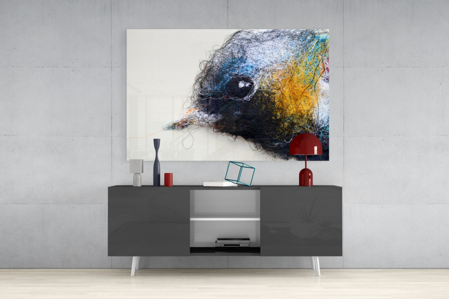 Modern living room with colorful abstract bird glass art displayed above dark console table with red lamp and decorative accessories.