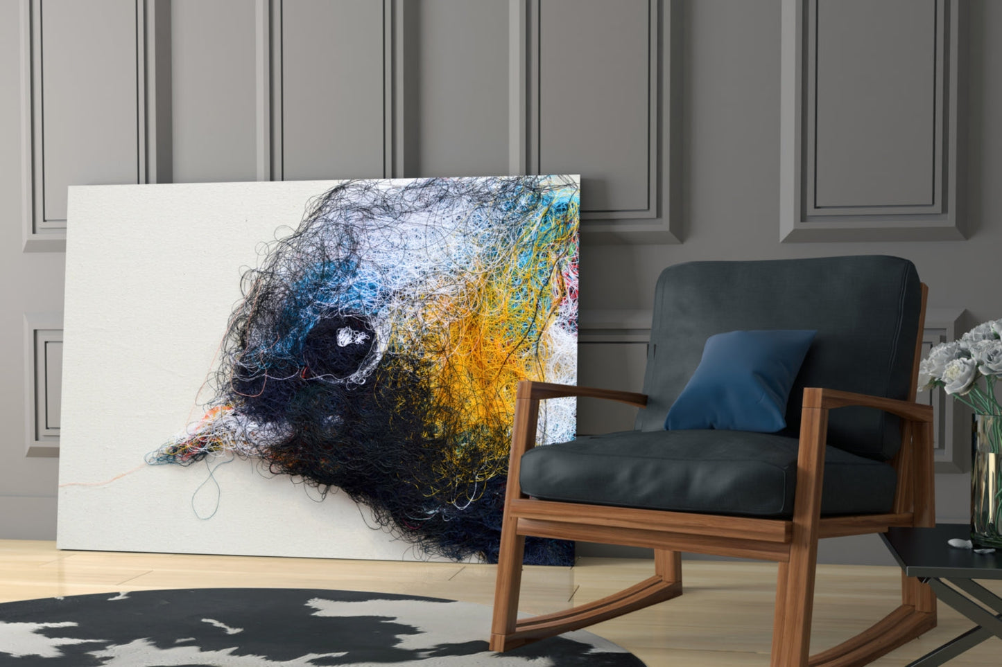 Abstract bird head artwork in black, blue, and yellow tangled lines displayed on white canvas beside mid-century wooden chair.