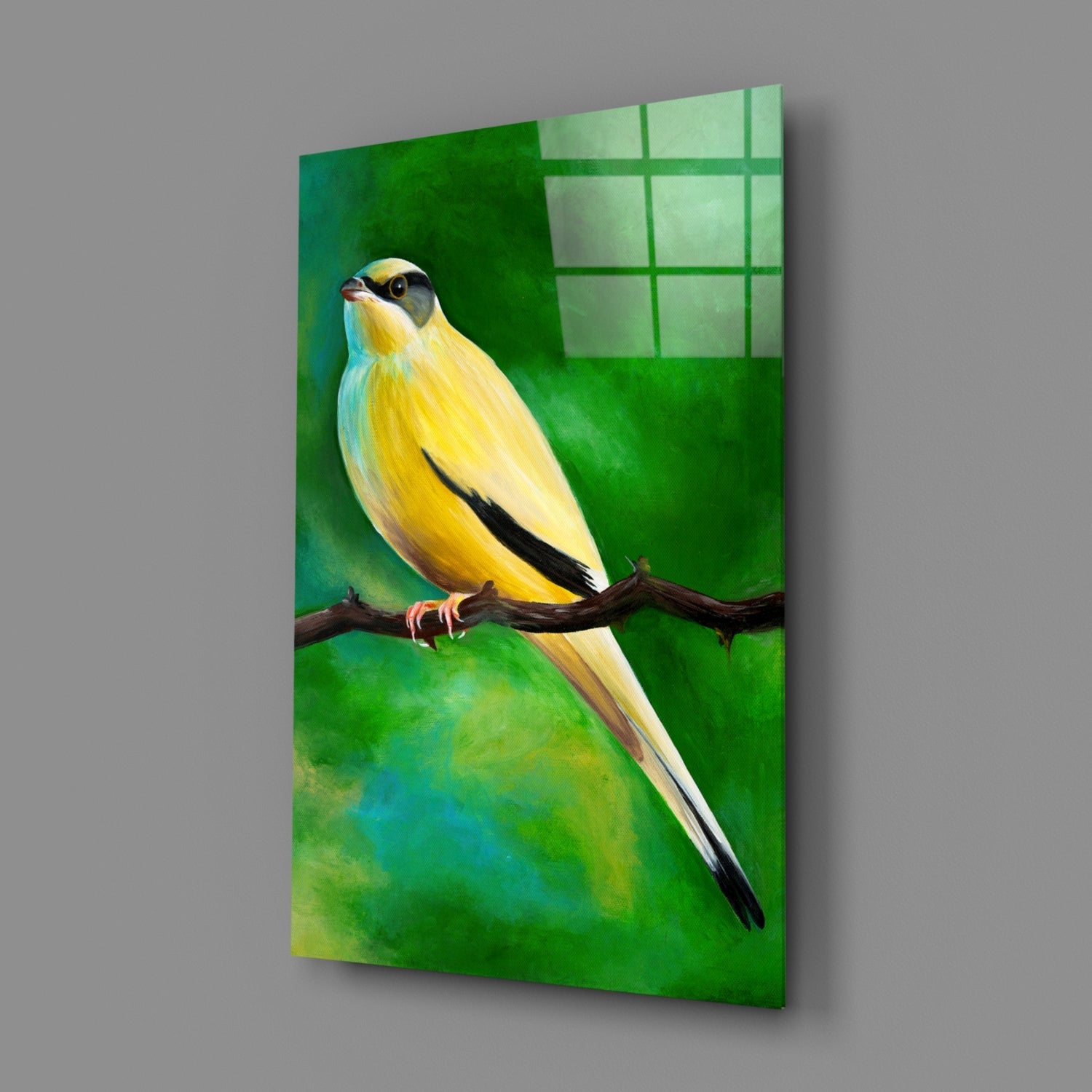 Yellow and black bird perched on brown branch against green gradient glass panel with window grid reflection.