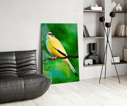 Yellow and green glass wall art depicting a bird perched on a branch, displayed in a modern living room setting.