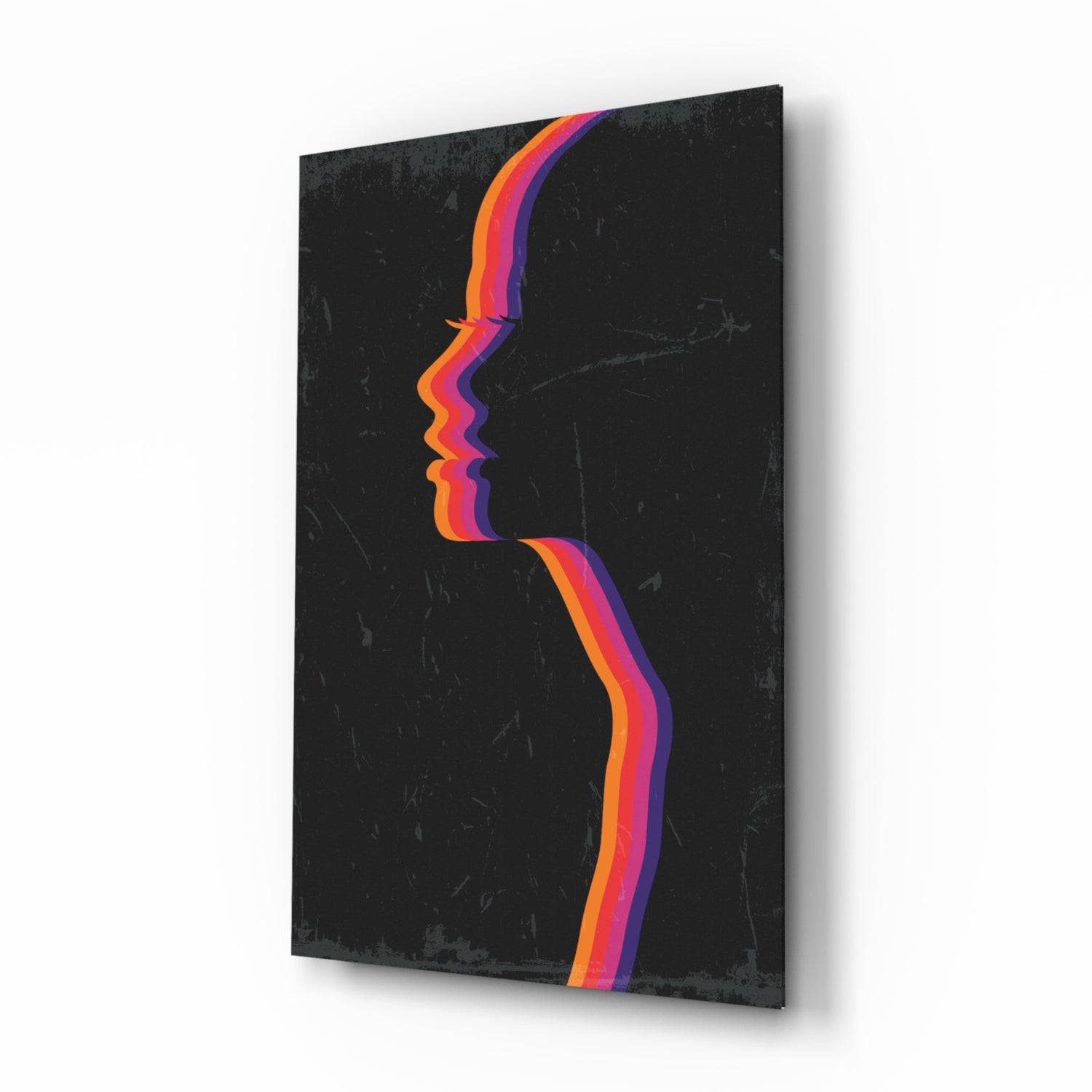 Angled view of black glass wall art with colorful layered silhouette profile in orange, pink, and purple stripes.