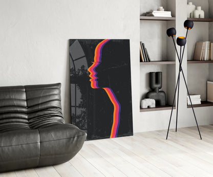 Modern living room with dark leather sofa, abstract colorful striped face artwork on black canvas, and tripod floor lamp with black spheres.