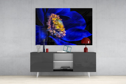 Modern entertainment center with gray media console displaying mounted TV showing blue flower artwork with yellow center and purple petals.