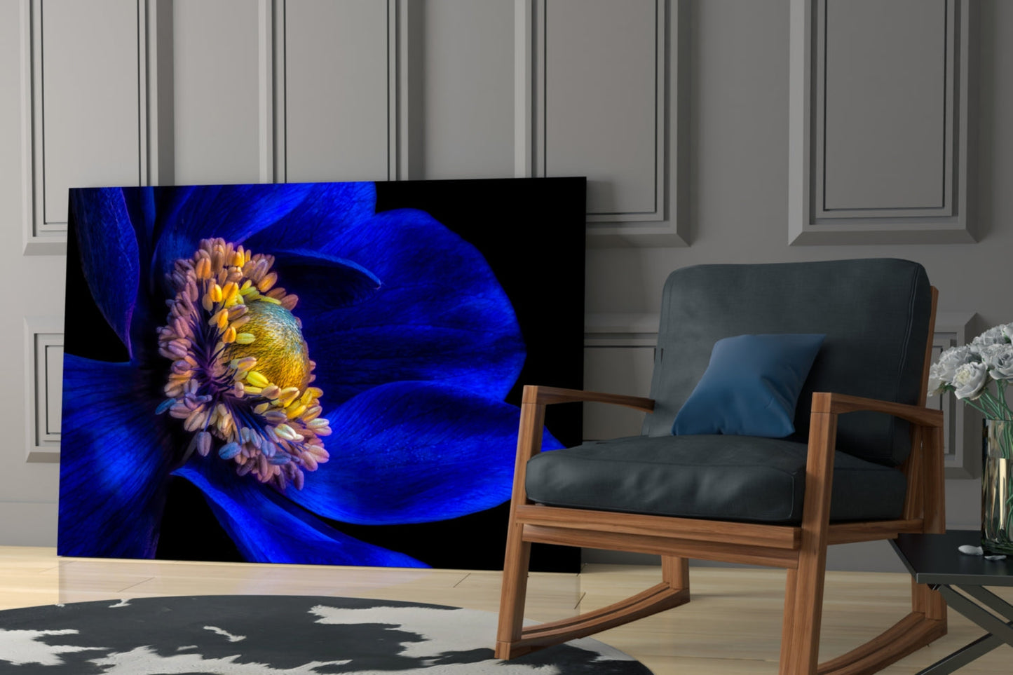 Blue floral glass art panel displayed in modern living room setting with wooden chair and paneled wall backdrop.