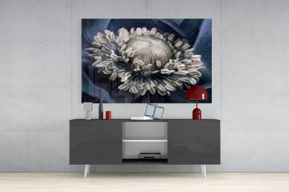 Gray Flower Glass Wall Art displayed above gray media console with white legs, showing monochromatic daisy photograph with red lamp and accessories.