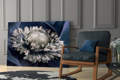Gray flower glass wall art displaying a white and gray gerbera daisy on dark blue background, displayed in modern living room setting.