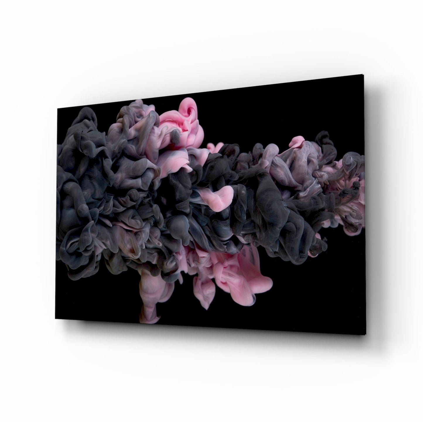 Glass wall art mounted on white surface displaying swirling black and pink smoke clouds against black background.