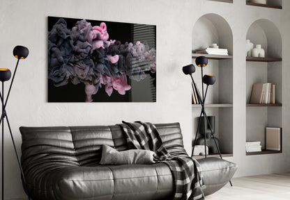 Black and pink swirling smoke clouds on dark background, displayed above gray leather sofa in modern living room.