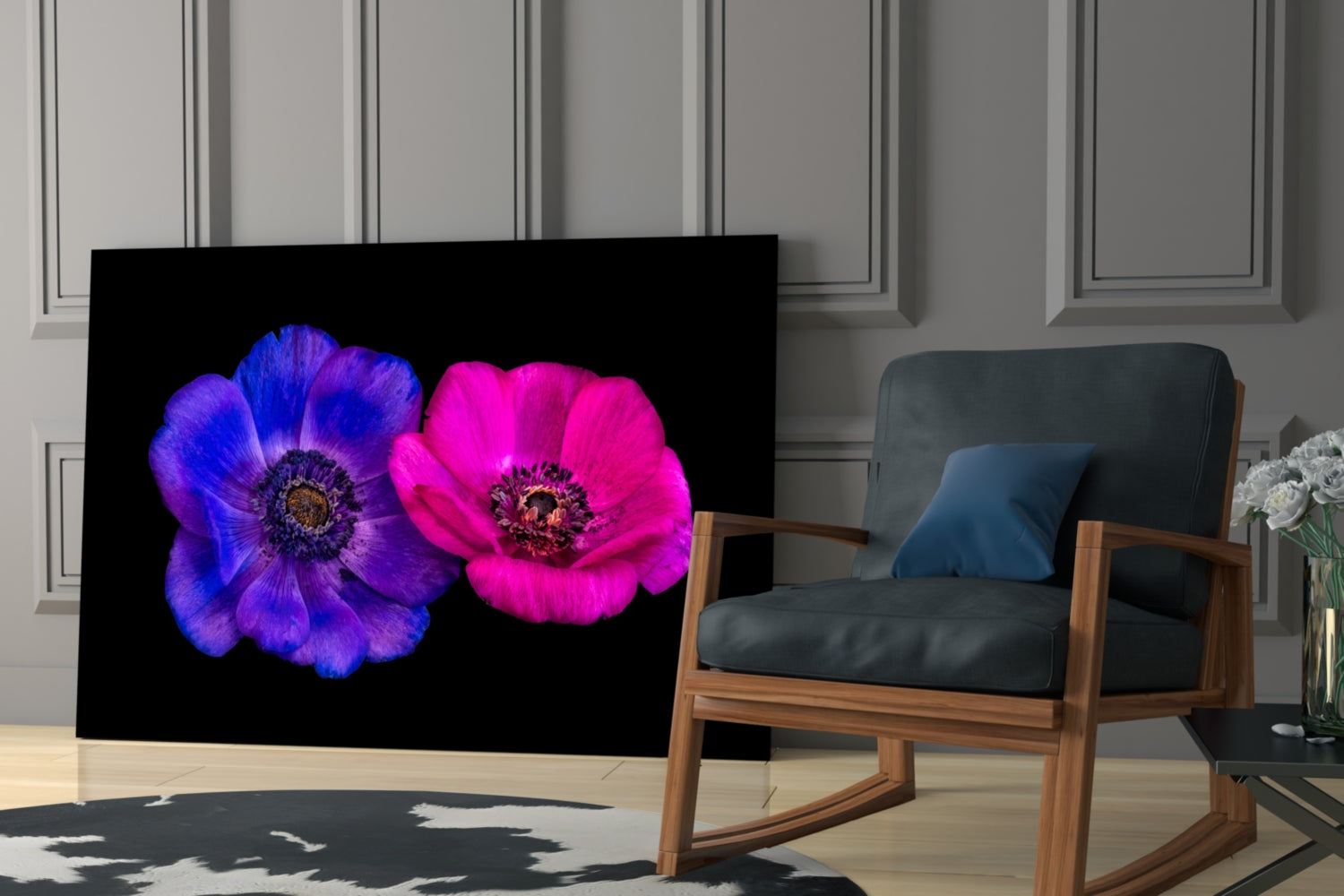Glass wall art featuring two vibrant anemone flowers—one blue-purple, one magenta-pink—displayed in a modern living room setting.