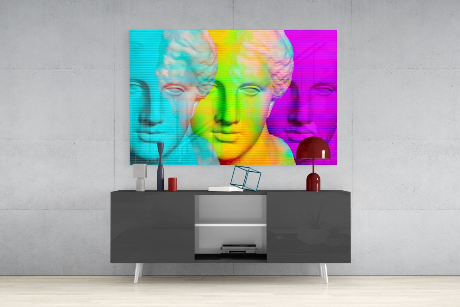 Pop art style glass panel with three colorful classical bust profiles in cyan, yellow-green, and magenta displayed above modern dark console table.