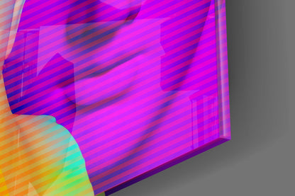 Angled 3D view of glass wall art with vibrant magenta, purple, blue, orange, and cyan striped pattern against gray background.