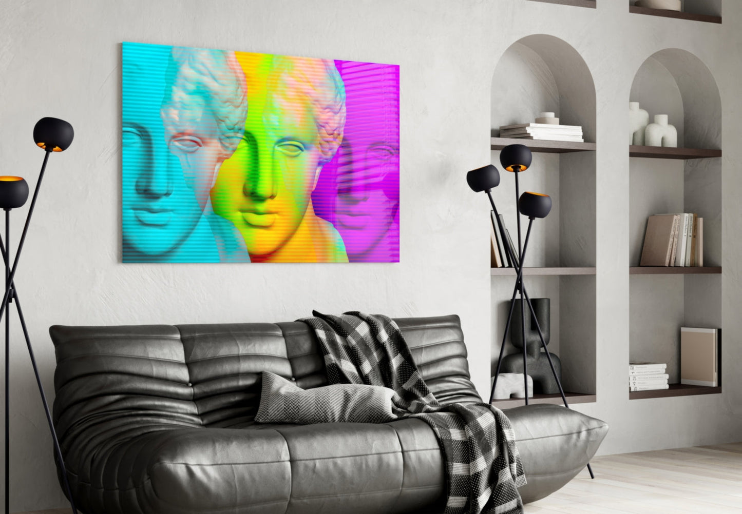 Vibrant pop art glass wall panel displaying colorful classical bust portraits in cyan, lime green, yellow, and magenta above a black leather sofa in modern living room.