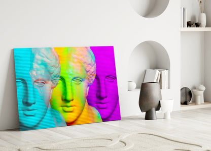 Vibrant pop art glass wall panel featuring three classical busts in cyan, lime green, and magenta gradients, leaning against white interior wall with shelving.