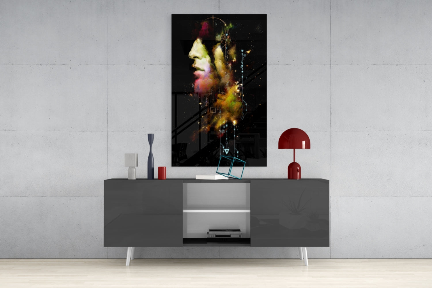 Colorful portrait glass art with yellow and red tones displayed above gray media console in modern living room setting.