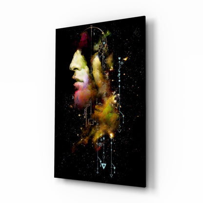 Glass wall art displaying a profile portrait with colorful powder effects and geometric symbols on black background.