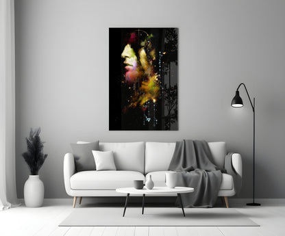 Modern living room with white sofa displaying colorful abstract portrait glass art on wall above.