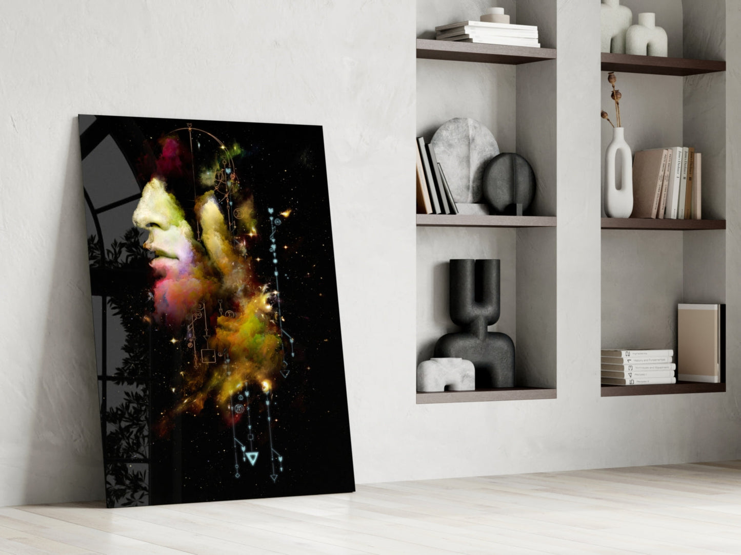 Modern interior scene featuring colorful abstract glass art leaning against wall with built-in shelving displaying decorative objects and books.