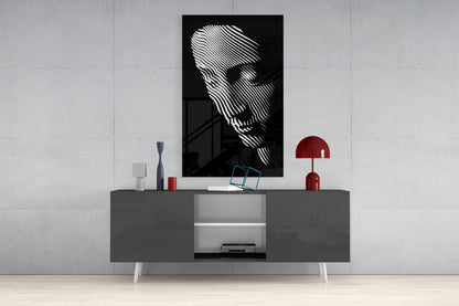 Black and white striped portrait artwork displayed above gray media console with red lamp and decorative accessories in modern interior setting.