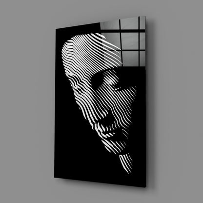 Black glass wall art panel featuring white linear striations forming a contemplative face profile, angled three-quarter view with shadow casting.