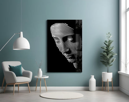 Black glass wall art featuring white striped abstract face profile displayed in modern living room with teal walls and minimalist furniture.