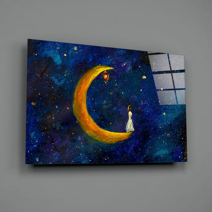 Glass wall art panel angled right, showing painted crescent moon with lantern and figure against deep blue starry night sky with window panes.