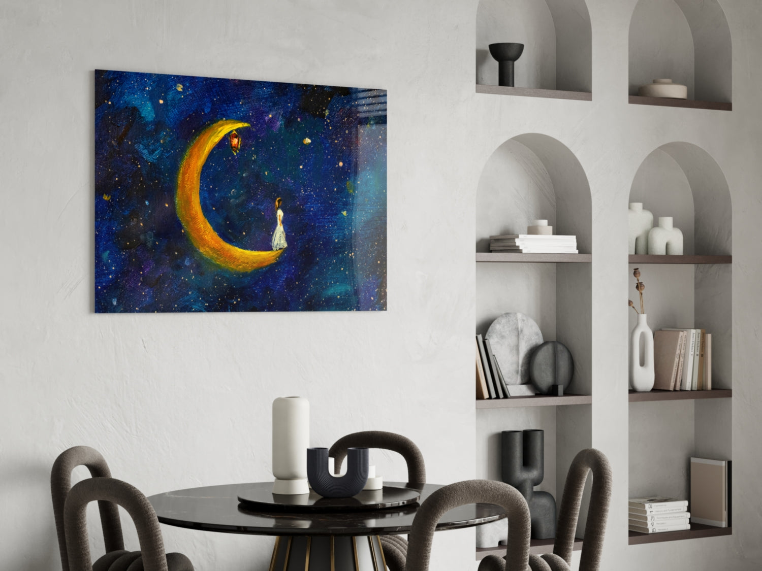Moon House Glass Wall Art depicting a glowing golden crescent moon with a figure in starry blue night sky, displayed above a dining table.