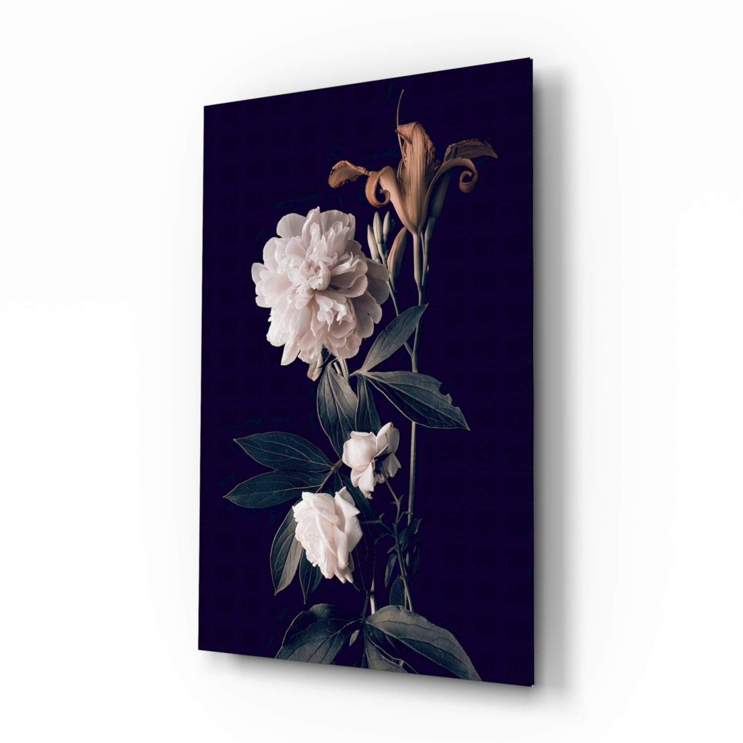 Angled view of glass wall art featuring white peonies and dried stems against dark navy background.