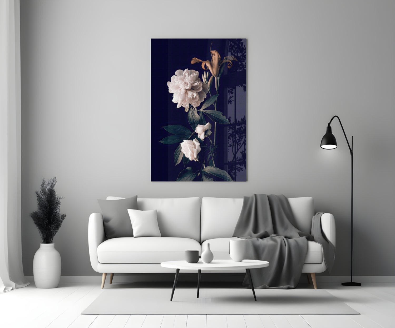 White rose glass wall art displaying pale flowers on dark navy background, displayed above light gray sofa in minimalist living room setting.