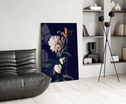 White rose glass wall art with dark navy background displayed in modern living room beside gray leather chair and black floor lamp.