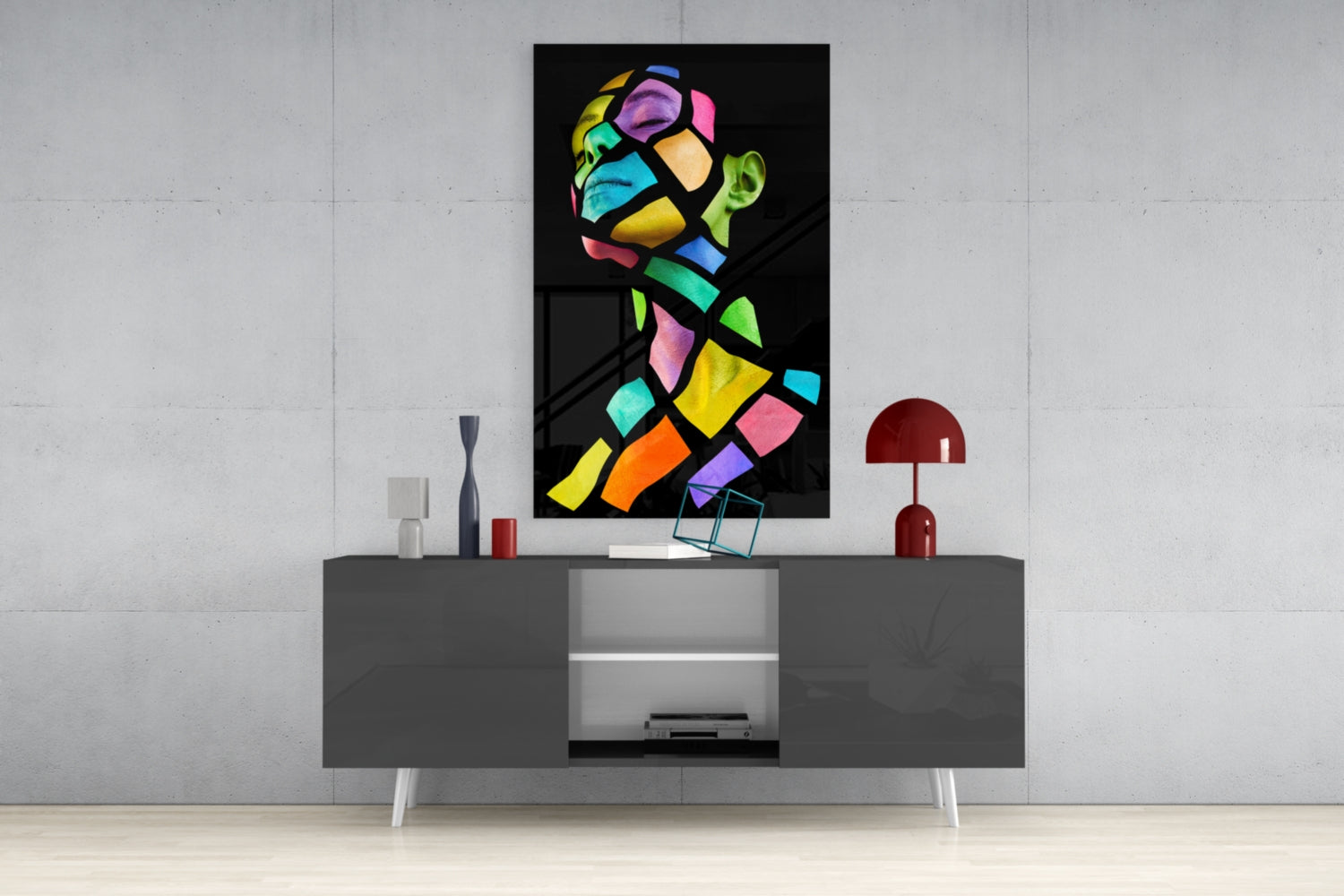 Colorful Spirit Glass Wall Art displayed above a gray media console, showing vibrant multicolored geometric portrait on black background.