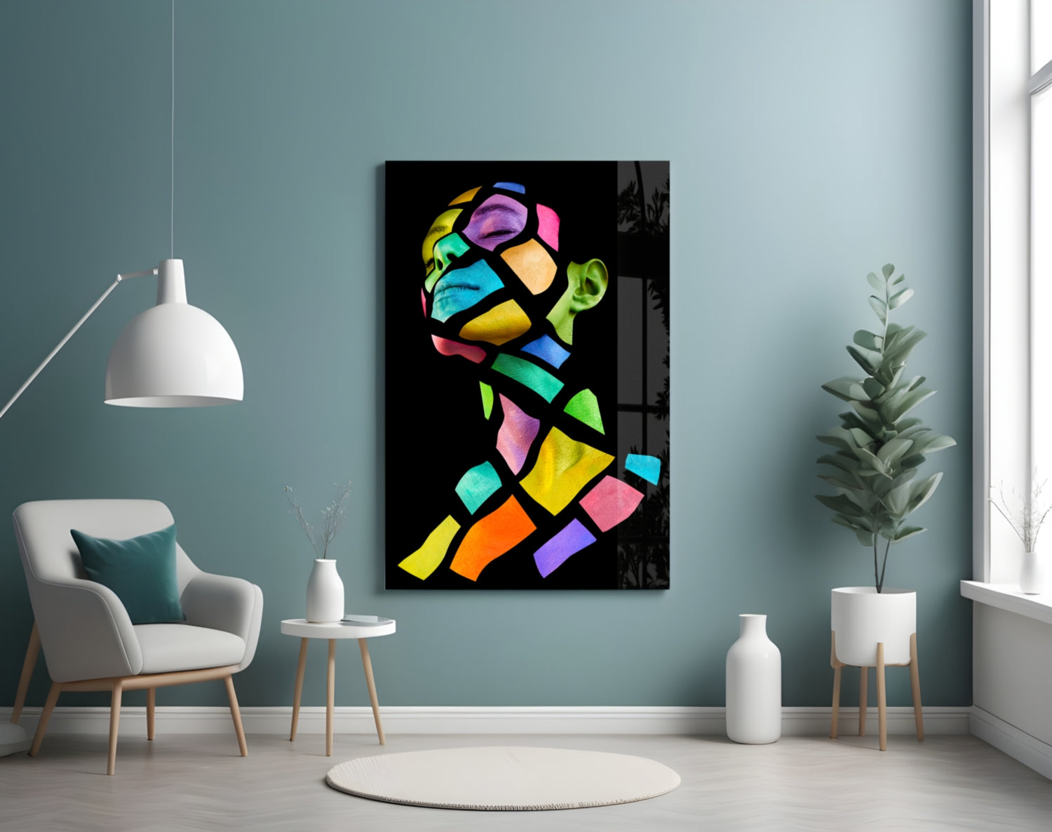 Colorful Spirit Glass Wall Art displayed on a teal wall above a white armchair in a modern living room setting.