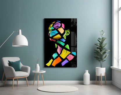 Colorful Spirit Glass Wall Art displayed on a teal wall above a white armchair in a modern living room setting.