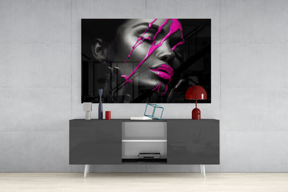 Modern living room setup displaying black and white portrait with magenta artistic overlays mounted above gray media console.