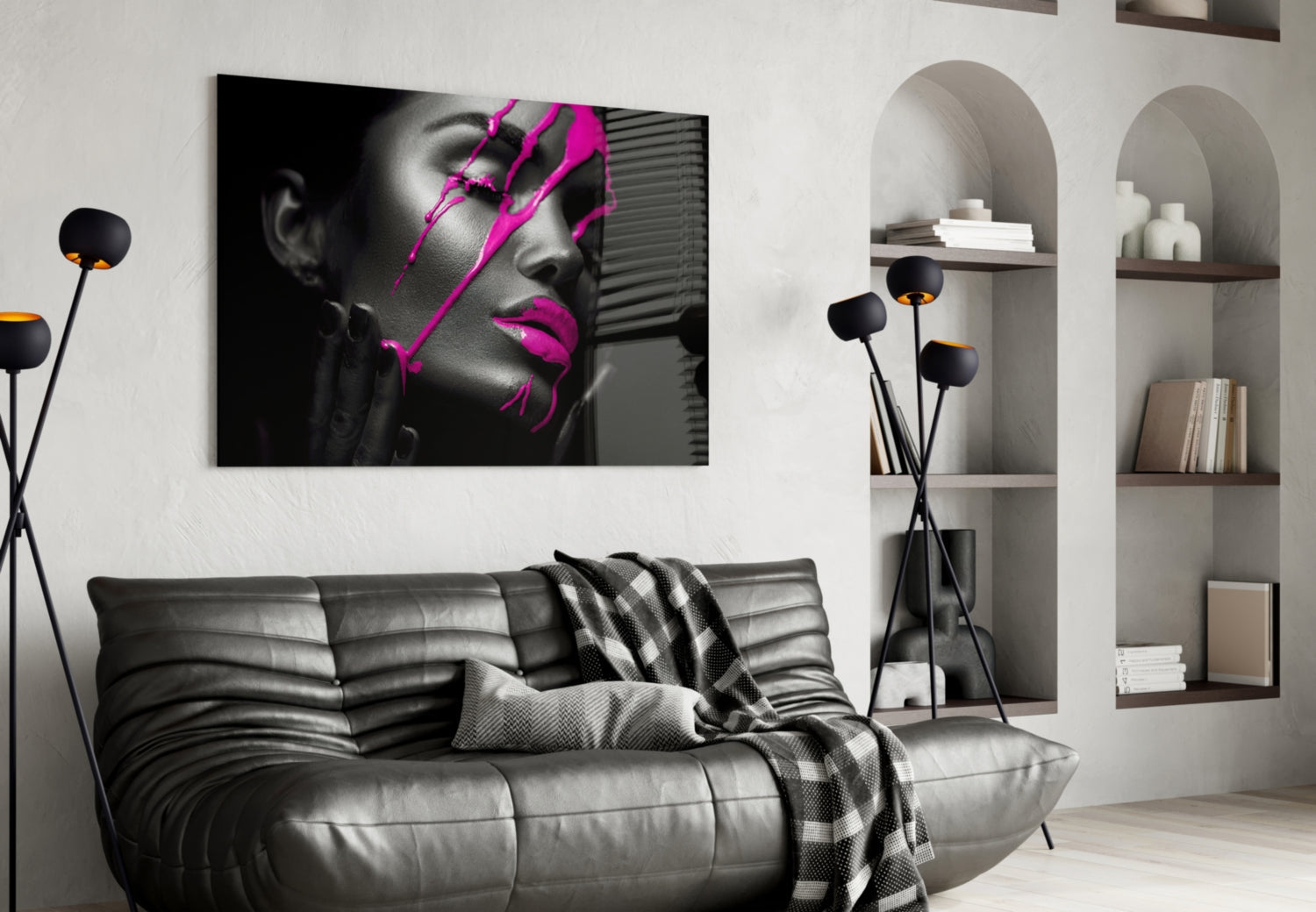 Modern living room with black leather sofa displaying purple woman glass wall art above, flanked by arched shelving.