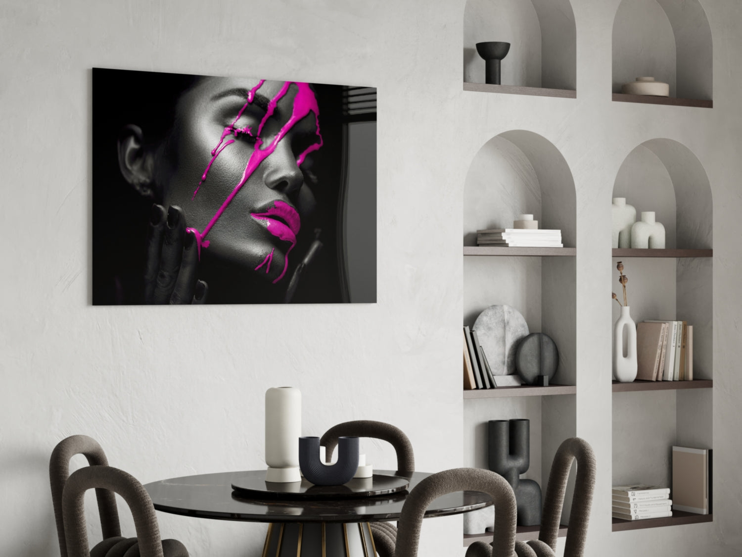 Black and white portrait with bright magenta geometric lines displayed above a round dining table in a minimalist interior.