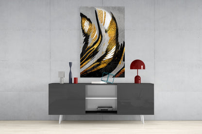 Golden Wings glass wall art with black, gold, and white striped feather design displayed above gray media console in modern interior setting.