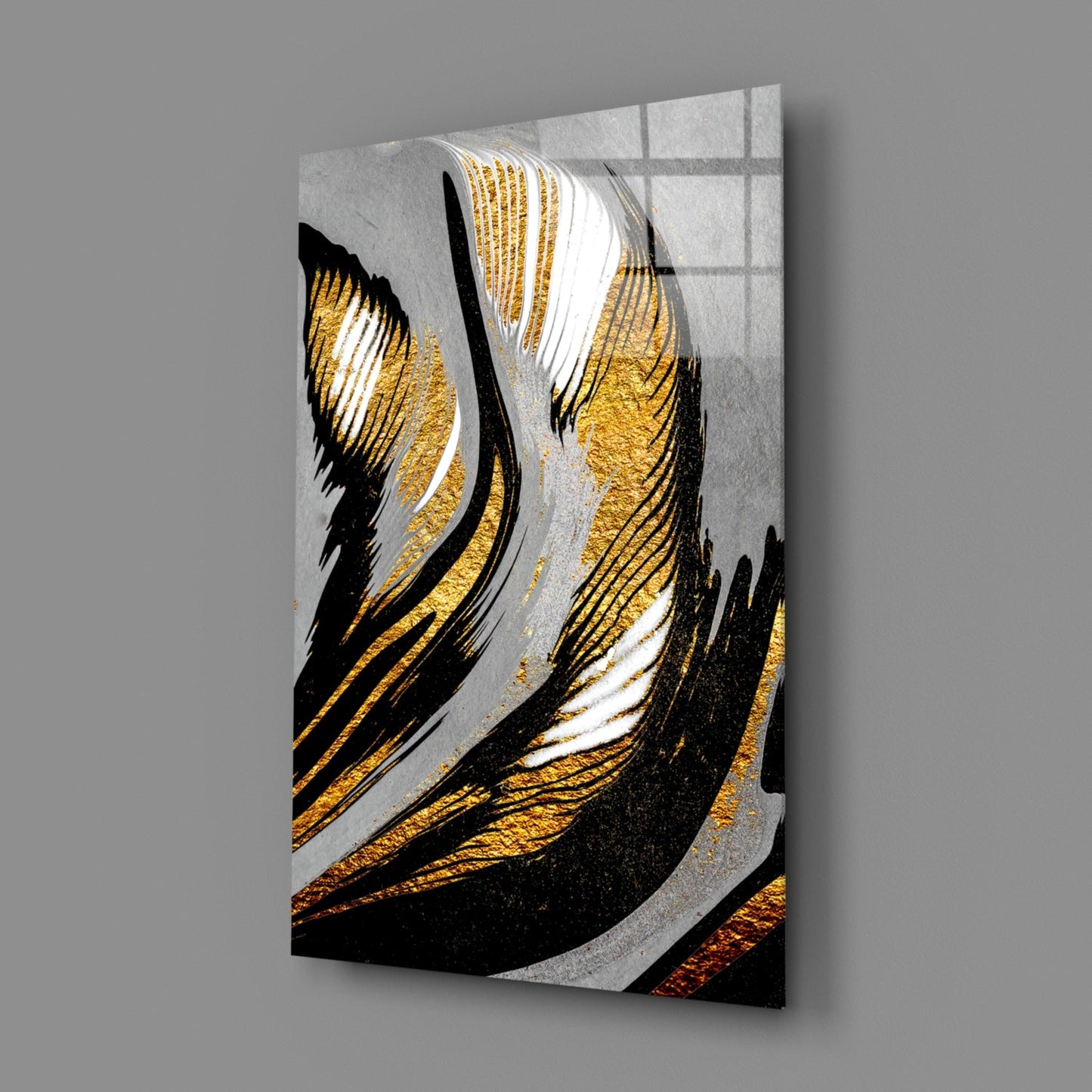 Angled perspective view of glass wall art featuring black and gold brushstrokes with white accents on gray background, mounted on wall.