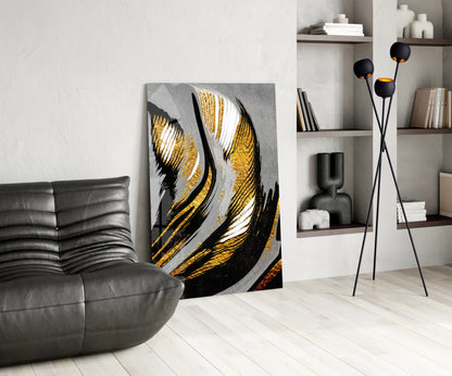 Golden Wings glass wall art displayed in modern living room beside grey leather sofa and black floor lamp with shelving.