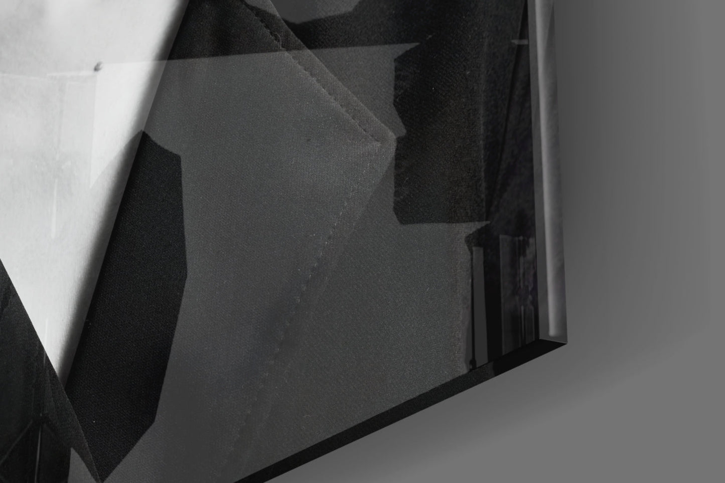 Close-up angle view of layered black and white glass art panels with geometric shapes and varying opacity levels.