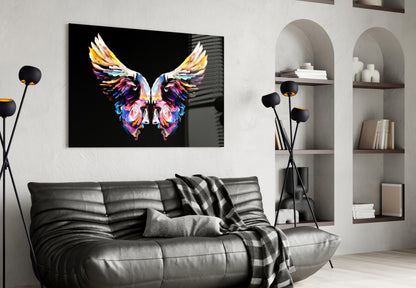 Colorful abstract butterfly glass art displayed above black leather sofa in modern living room interior.